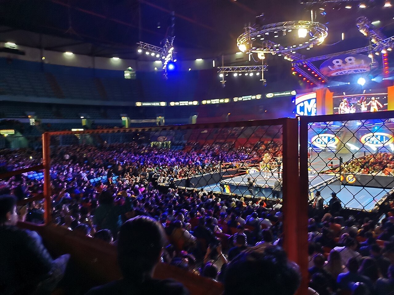 A packed crowd around the ring at Arena México